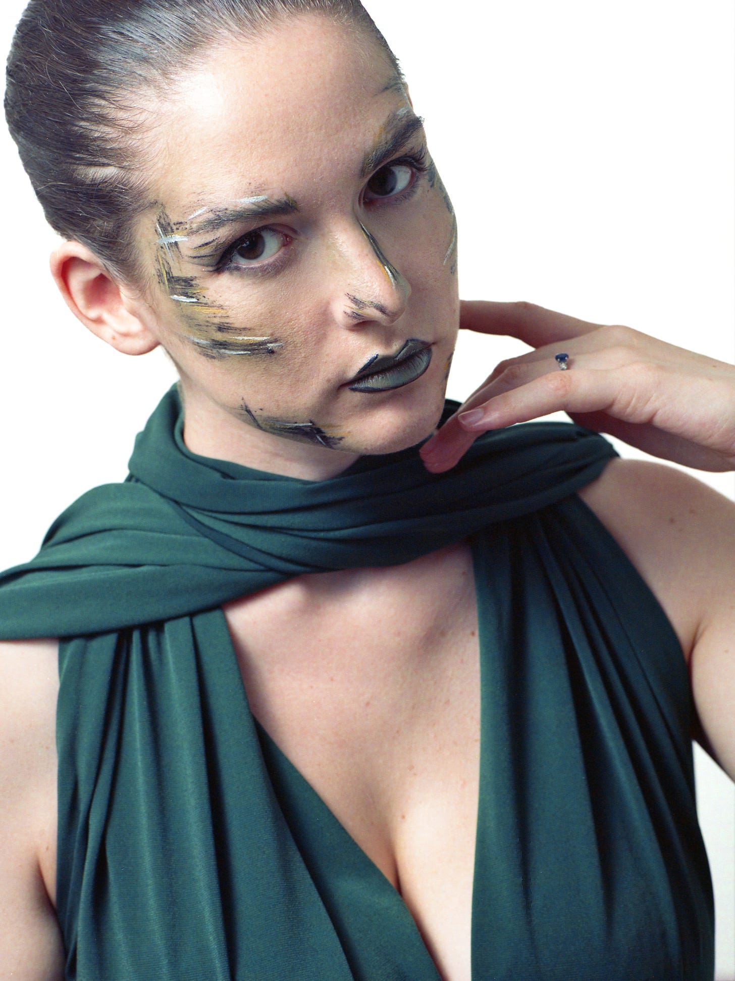 Film portrait of model with colored stripes makeup and green dress
