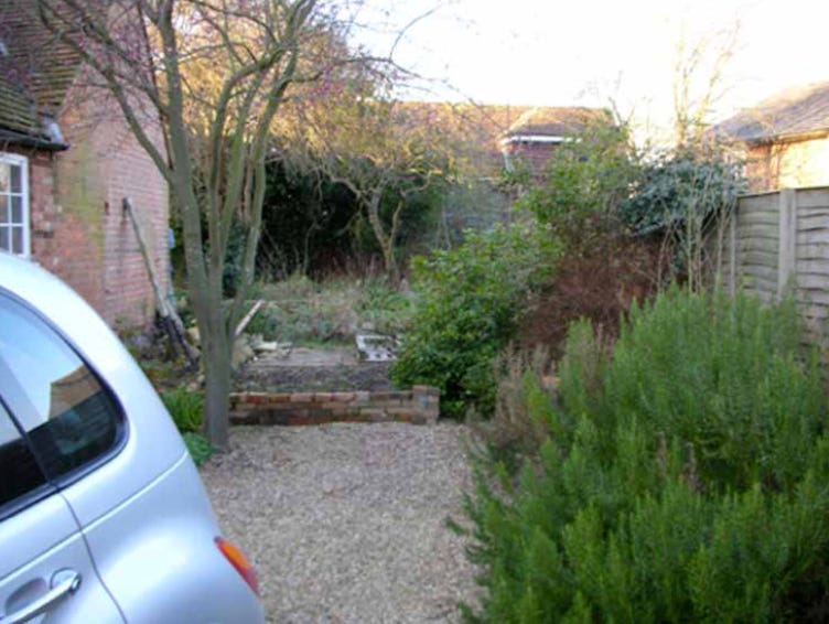 a car in a before photo of a garden