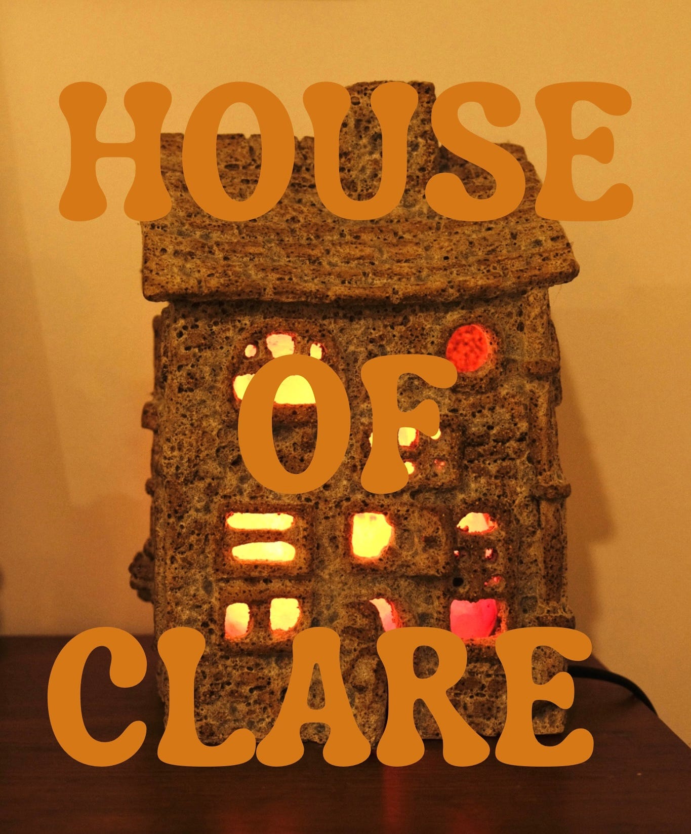 a ceramic piece of a house that Clare made, with writing "House of Clare" written over it