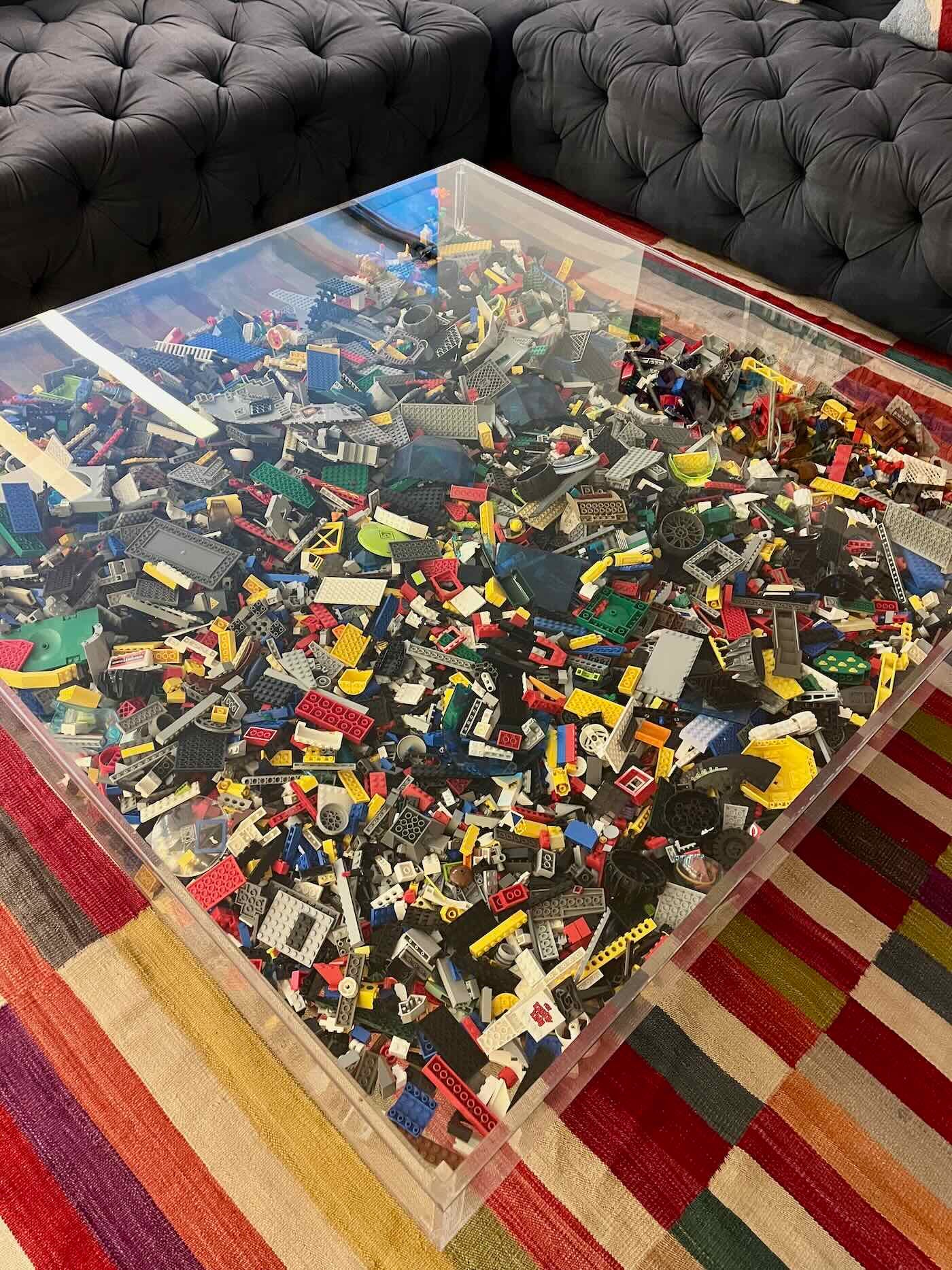 plexiglass coffee table full of Legos