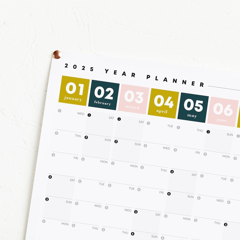 May include: 2025 year planner featuring a monthly calendar view. Each month is represented by a color-coded square: January (gold), February (dark teal), March (light pink), April (gold), May (dark teal), and June (light pink). The planner is designed with a clean, minimalist aesthetic and includes days of the week labels. May include: 2025 year planner featuring a monthly calendar view. Each month is represented by a color-coded square: January (gold), February (dark teal), March (light pink), April (gold), May (dark teal), and June (light pink). The planner is designed with a clean, minimalist aesthetic and includes days of the week labels.