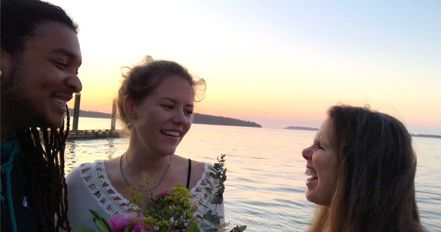 singing at water's edge with two friends