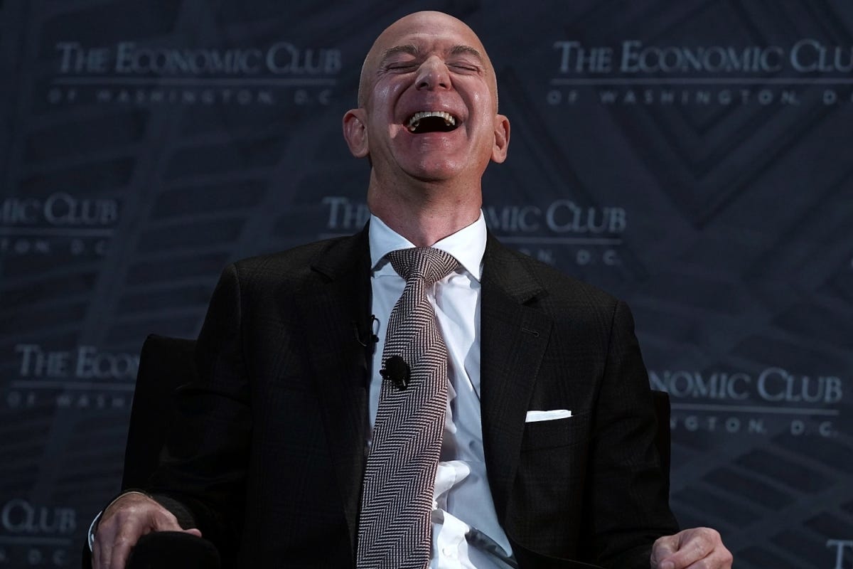 CEO and founder of Amazon Jeff Bezos laughs as he participates in a discussion during a Milestone Celebration dinner September 13, 2018 in Washington, DC. Economic Club of Washington celebrated its 32nd anniversary at the event.