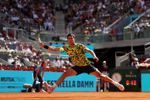 Carlos Alcaraz of Spain stretches for a forehand against Borna Coric of Croatia during the Men's Singles Semi-Final match on Day Twelve of the Mutua...