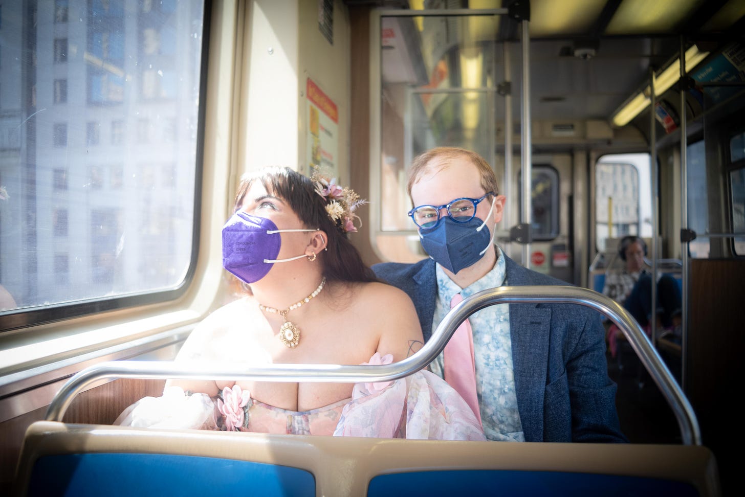 Daniella and Joe where their wedding garb and face masks while riding the Chicago El.