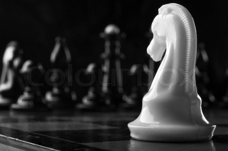White knight chess piece on the board ... | Stock image | Colourbox