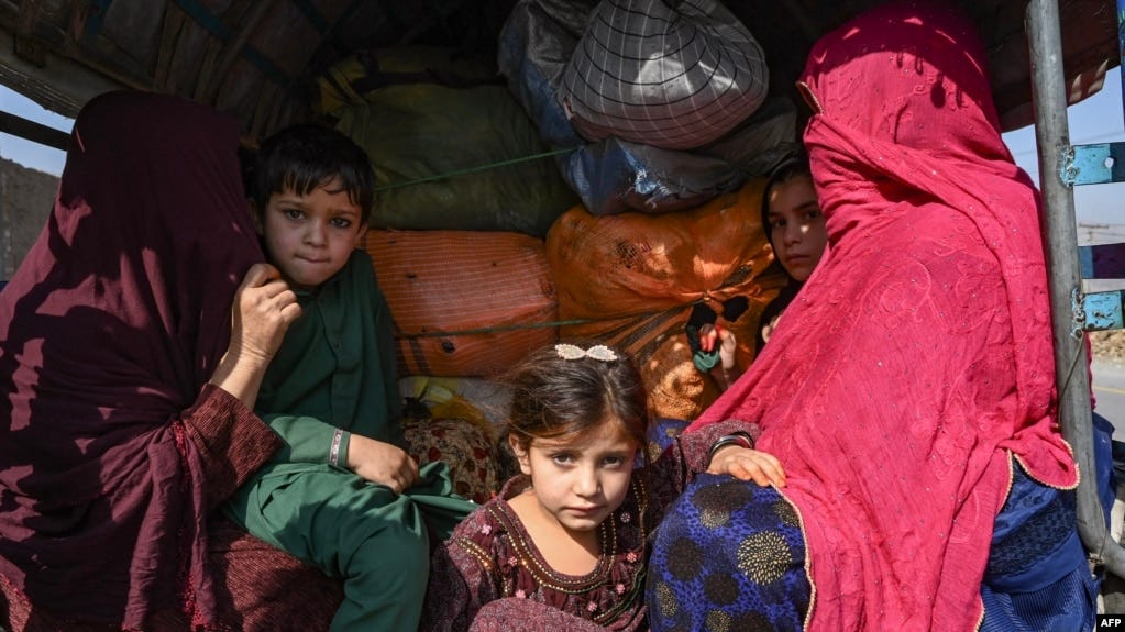 A family of Afghans sit on a vehicle in the Jamrud area of Khyber district on October 6 as they return to Afghanistan, following Pakistan's decision to expel people illegally staying in the country.