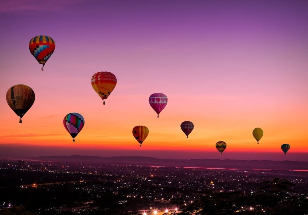Hot air balloons at sunset representing raising your vibration