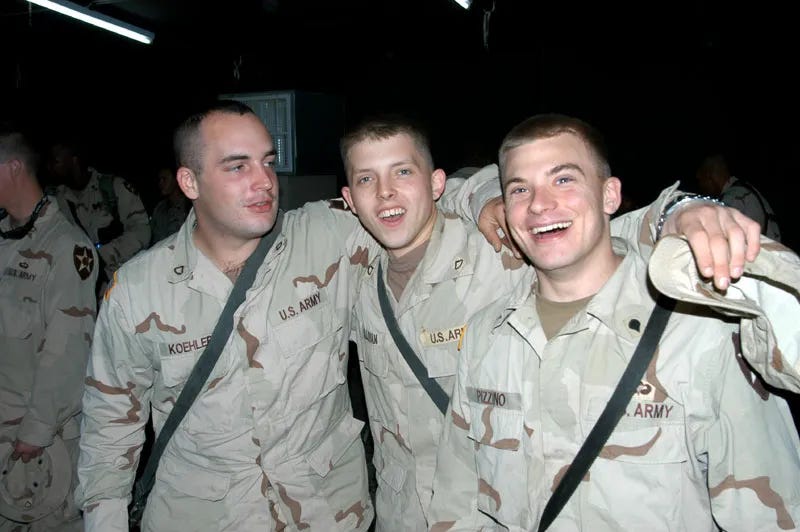 three young soldiers arm in arm smiling for the camera--hire a veteran