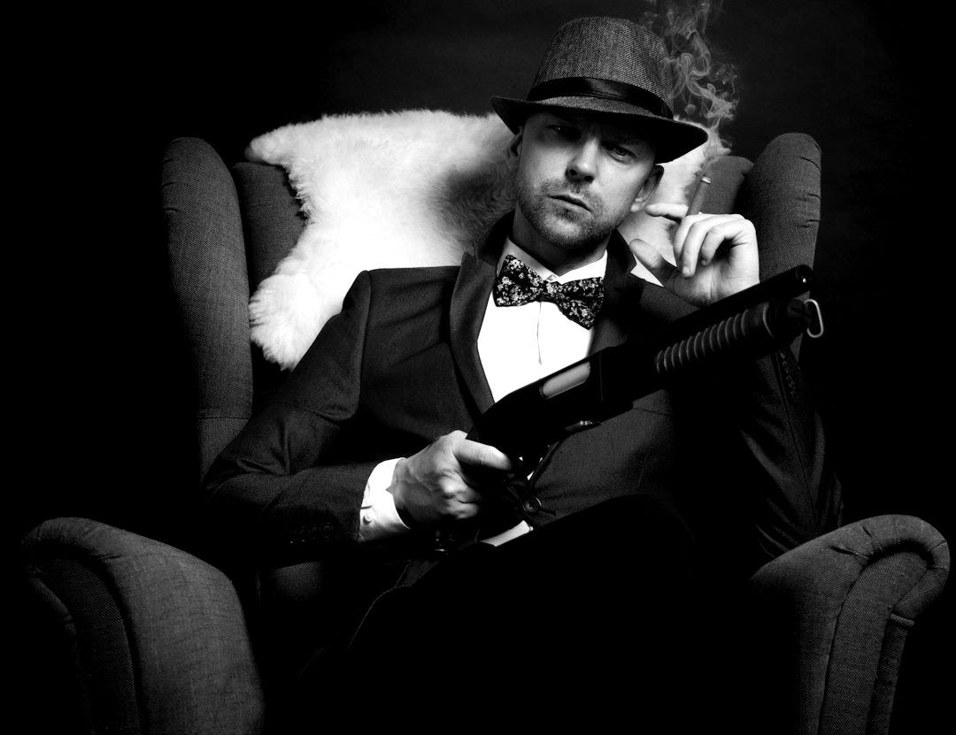 a man in a tuxedo smoking a cigarette a man in a tuxedo smoking a cigarette