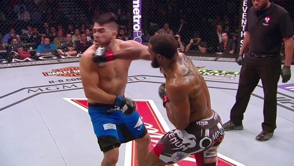 tyron woodly right hook on kelvin gastelum ufc 183 fight images 2015