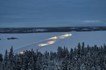Cars on the Dettah Ice Road with cloudy skies on the morning of January 11, 2023