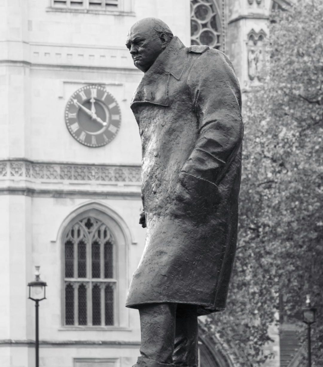 a black and white photo of a statue of a man a black and white photo of a statue of a man