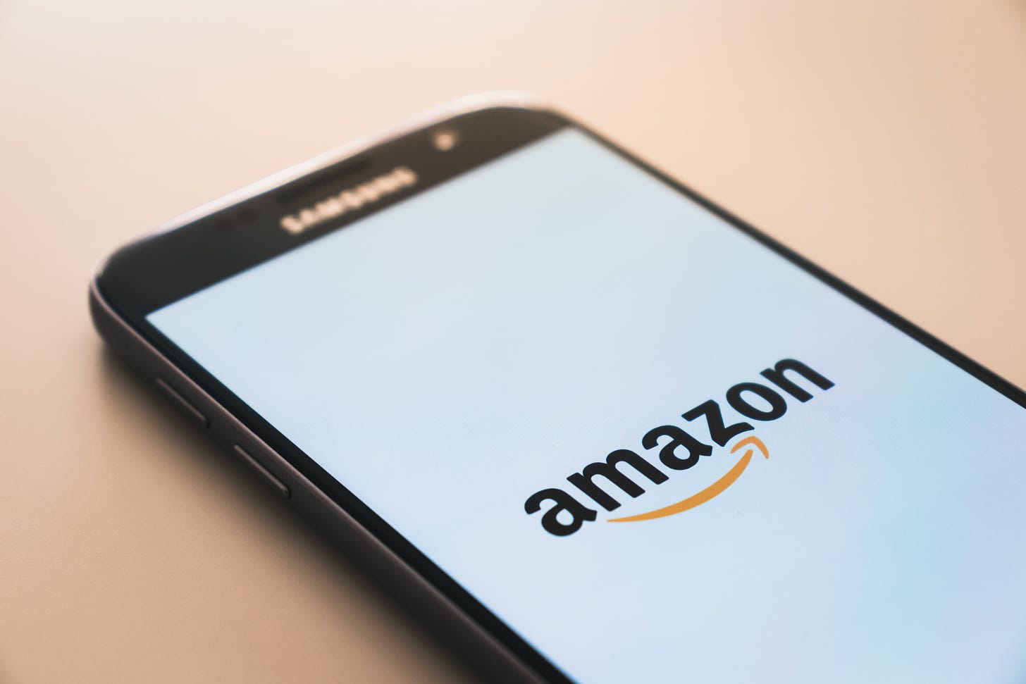 Smartphone showing the Amazon logo on its screen