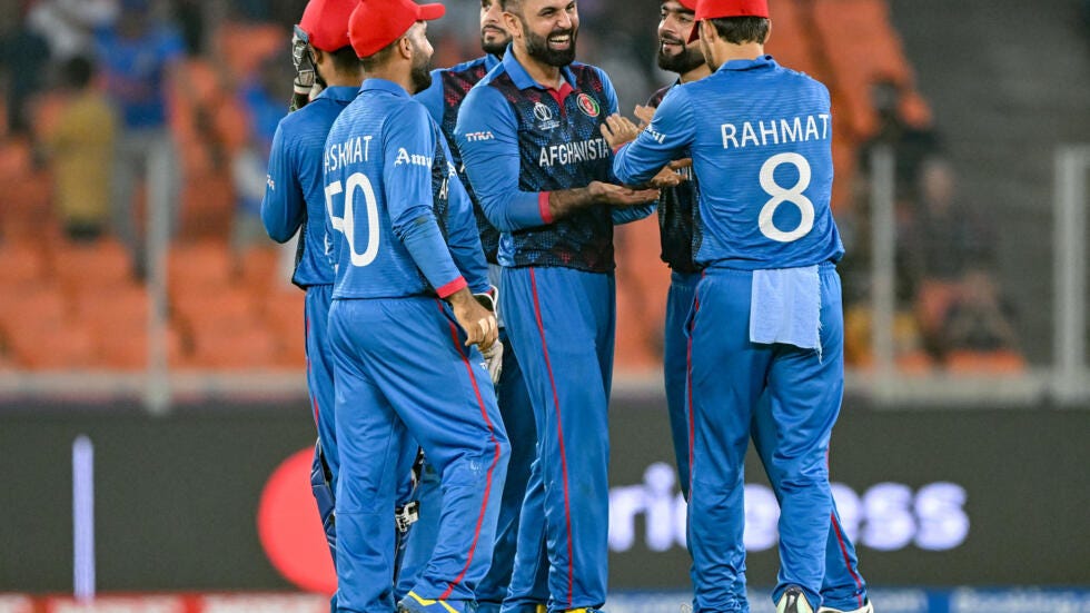 Team spirit: Afghanistan's Mohammad Nabi celebrates with teammates after taking the wicket of South Africa's David Miller