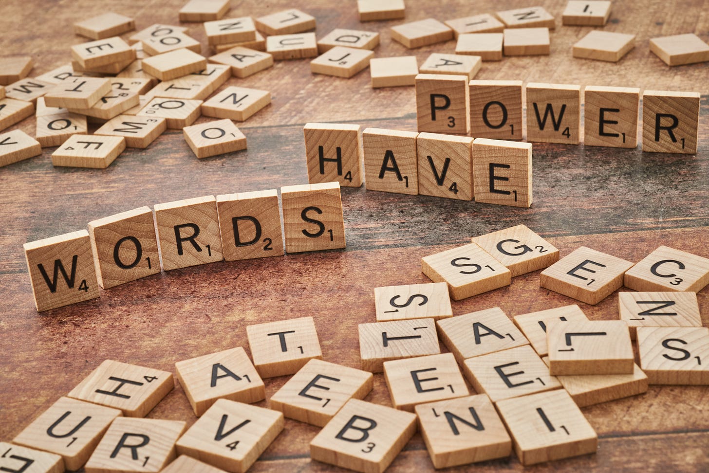 Scrabble tiles spelling out "Words Have Power"