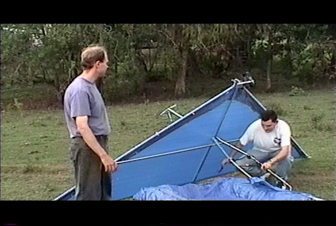Two guys preparing a homemade hang glider.