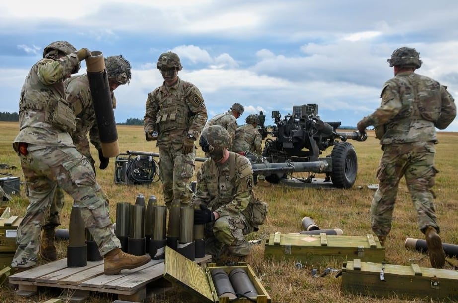 U.S. soldiers handling munitions, underscoring the depletion of resources.