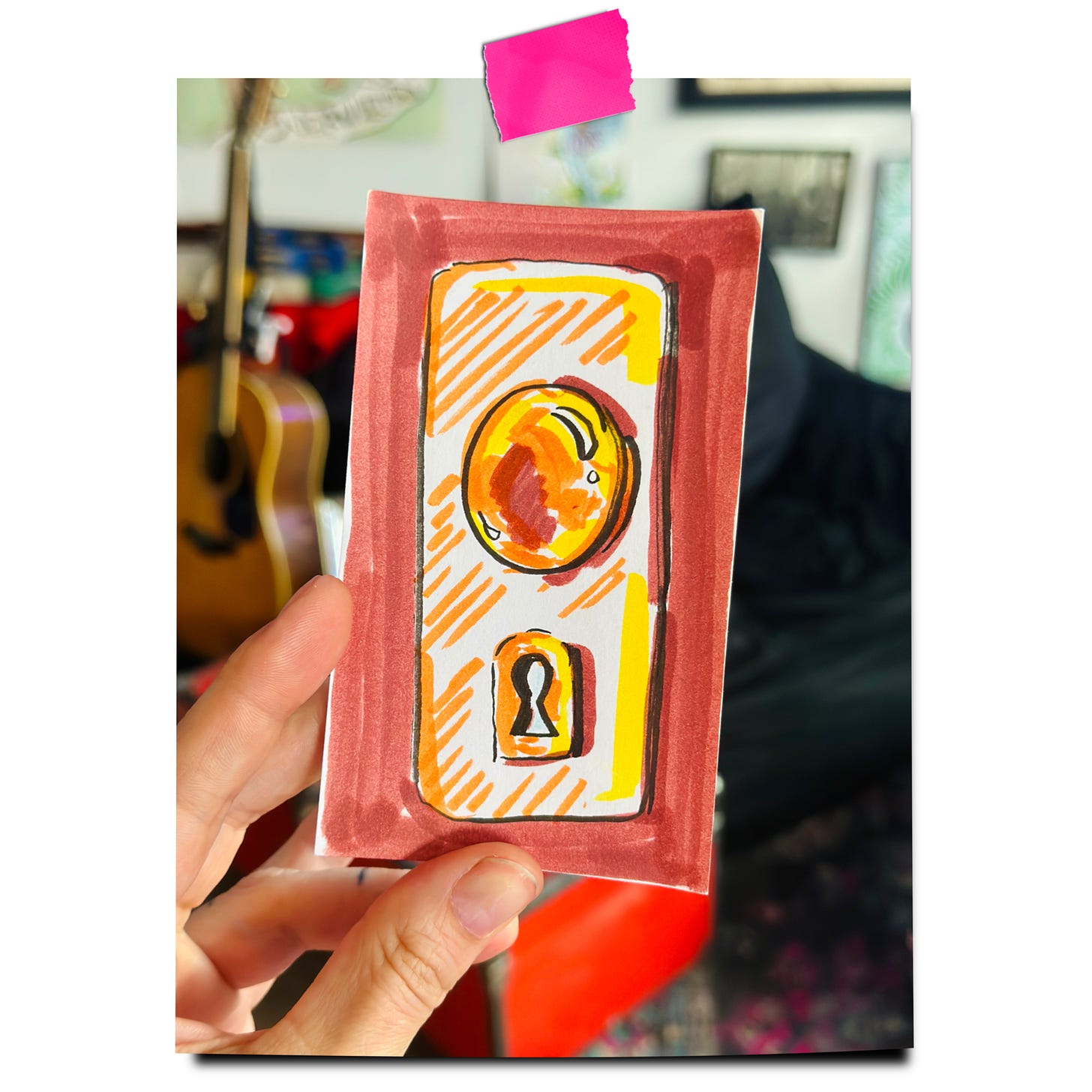 a doorknob on a hand drawn oracle card held up by the author