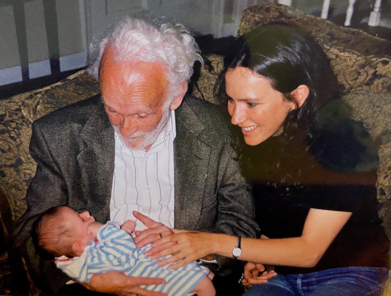 My dad and me smiling at my baby nephew.