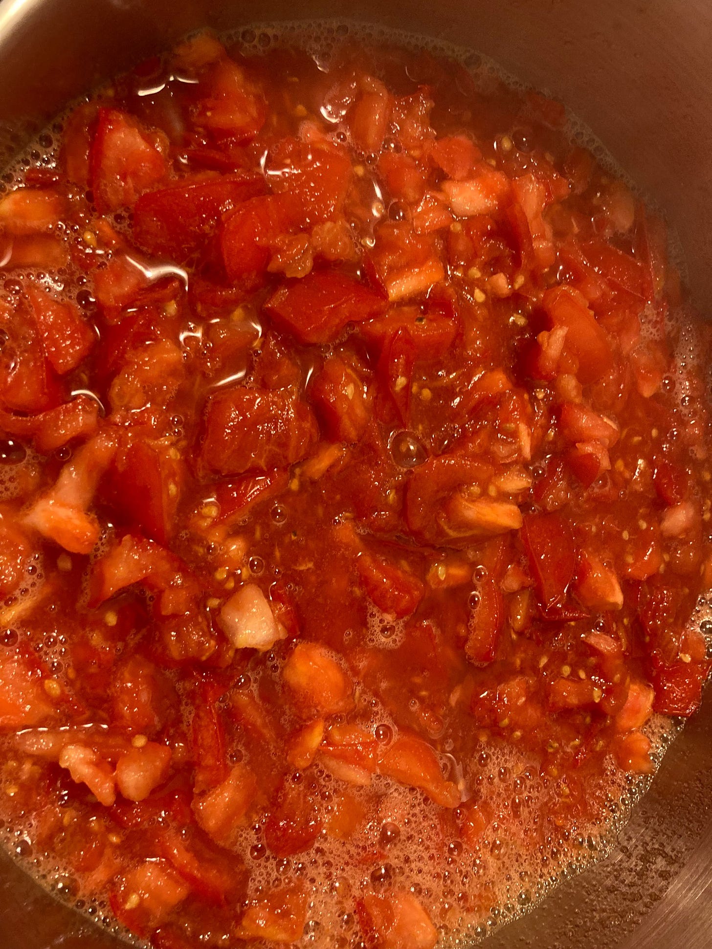 Chopped tomatoes in a pot - top down view