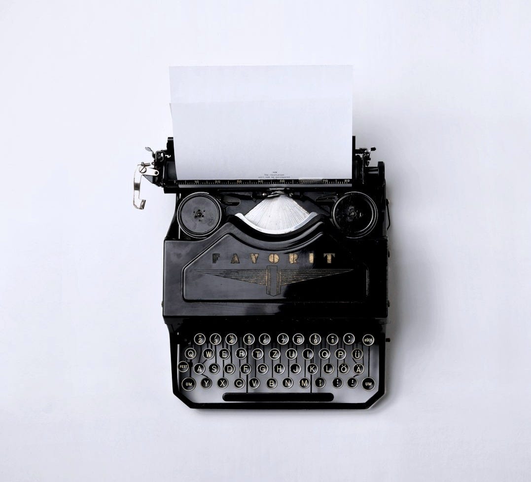 black Fayorit typewriter with printer paper