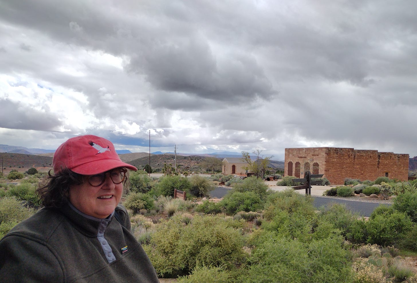 Annette with old buildings in semi-desert