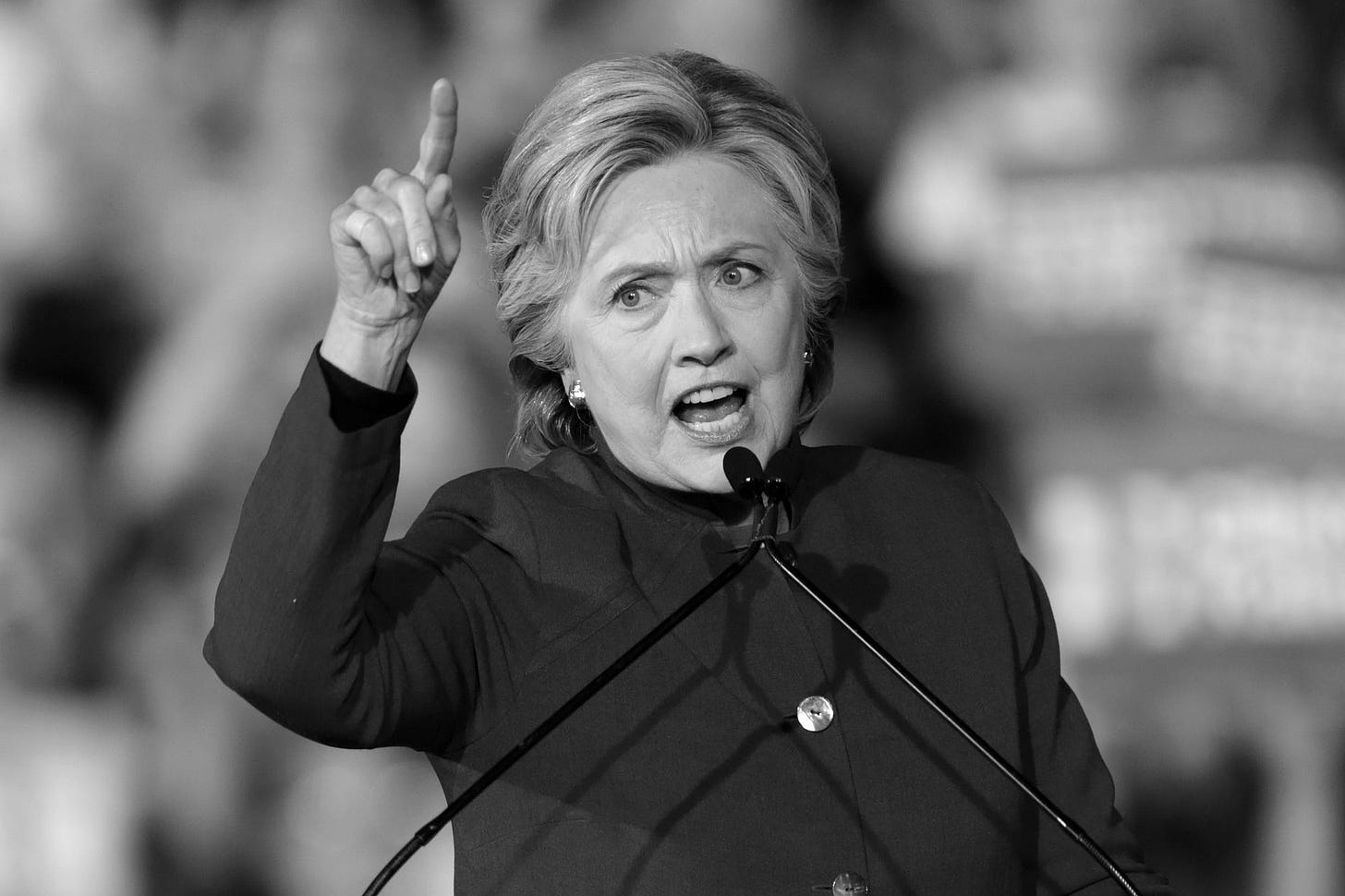 Photo of Hillary Clinton admonishing us with a finger in the air.