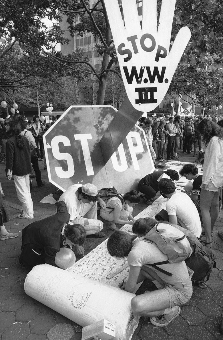 Early arrivals sign a petition seeking disarmament in a park near the United Nations in New York as crowds began forming for a march and rally in support of nuclear disarmament on June 12, 1982. (AP Photo/Warren Jorgenson)