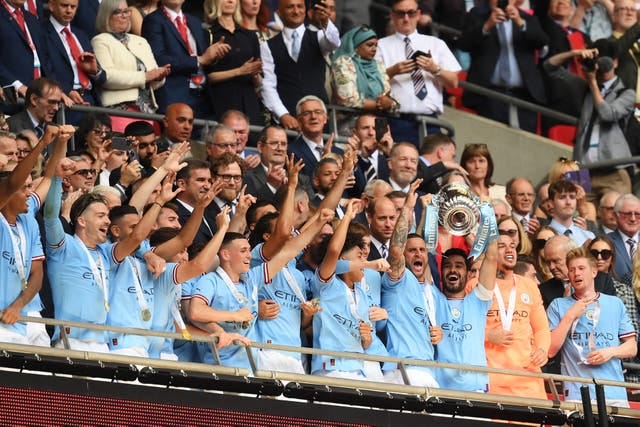 Manchester City's players lifting the FA Cup Trophy after they beat Man United to win it