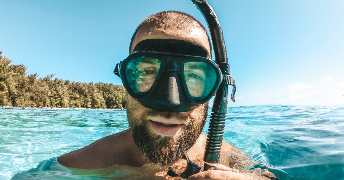 A man in what is, I admit, actually a swim mask and snorkel, but which look uncannily like all the press photos of Apple's dork goggles.
