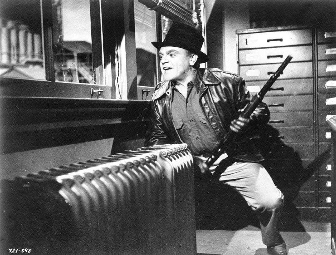 James Cagney, holding rifle, crouches beside window, looking out.
