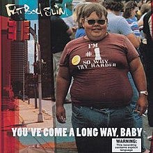 An image of an obese man holding a cigarette in his left hand. His shirt reads "I'M #1 SO WHY TRY HARDER" with a sticker on his right side. An additional image is seen on a left of a city street. Below the album's title, a Warning label appears on the bottom right in a style of a Tobacco warning message reading "WARNING: This recording contains explicit language".