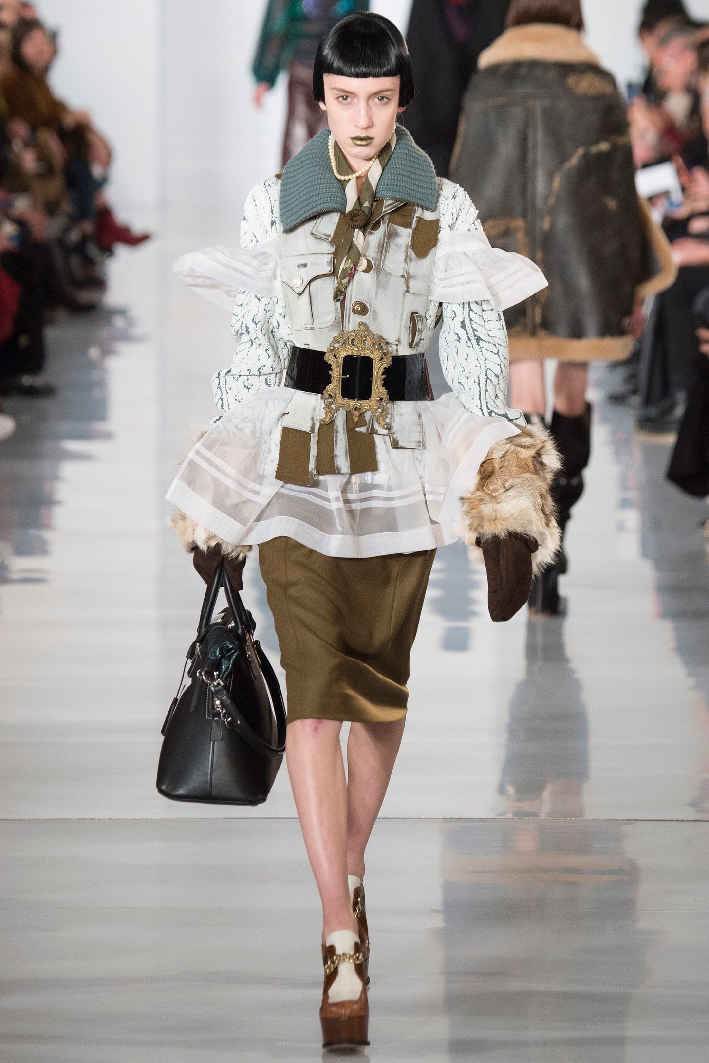 Image may contain Bag Handbag Accessories Accessory Human Person Clothing Apparel Sleeve Long Sleeve and Shorts