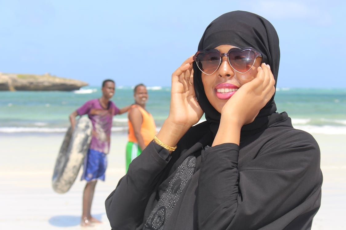 Free Smiling women enjoying a sunny day at the beach in Dhuusamareeb, Somalia, with friends. Stock Photo