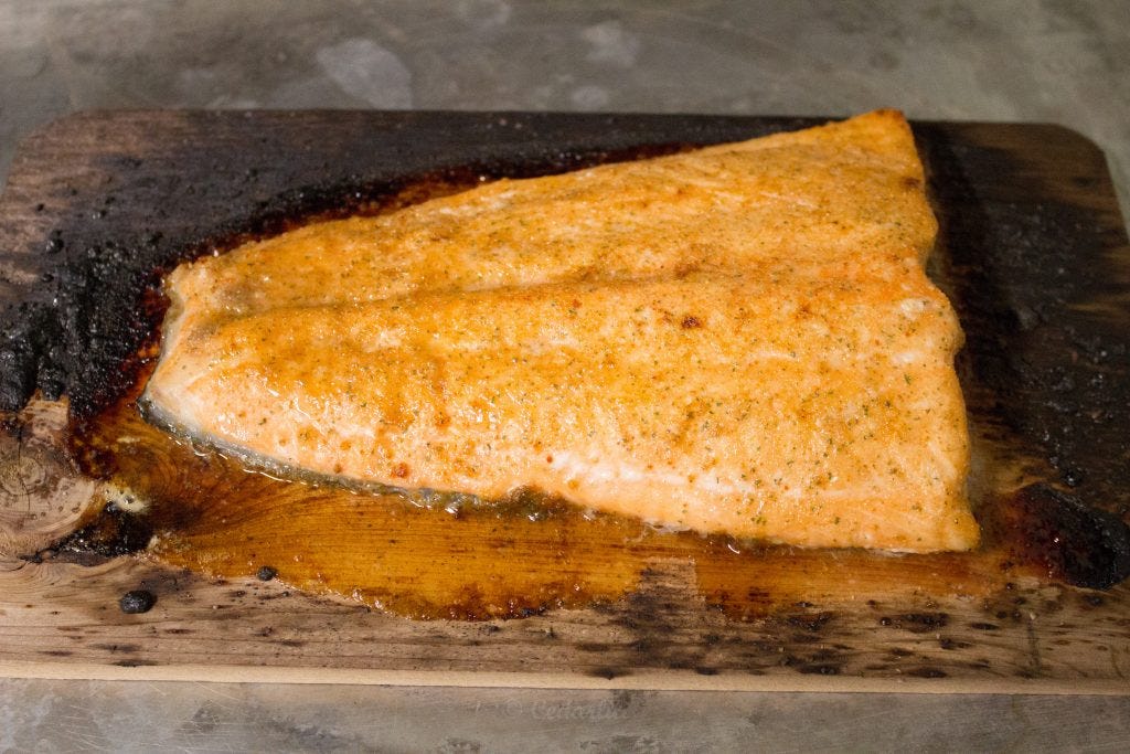 Finished fish on a slightly blackened plank