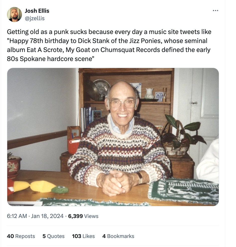 A tweet above a photo of an elder gentleman in a brown and white patterned sweater sitting in a dining room. The tweet: Getting old as a punk sucks because every day a music site tweets like "Happy 78th birthday to Dick Stank of the Jizz Ponies, whose seminal album Eat a Scrote, My Goat on Chumsquat Records defined the early 80s Spokane hardcore scene."