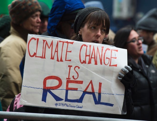 Climate activists rally, to urge politicians to stand against climate denial in New York in 2017.