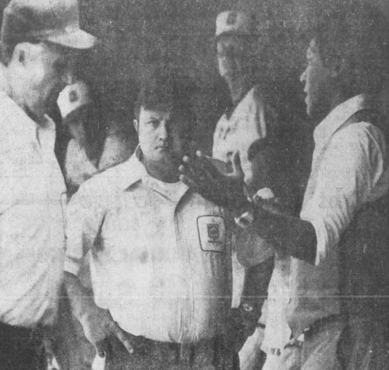 The umpires in discussion with the Braves' Bill Lucas.