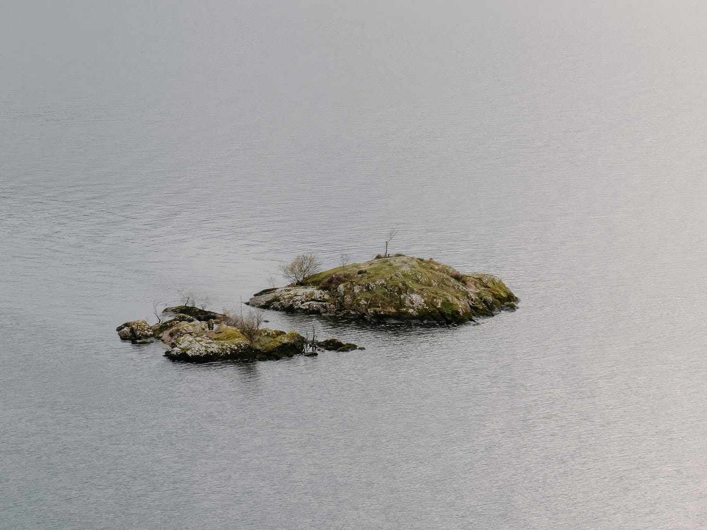 Picture of a small, mostly bare island in a lake.