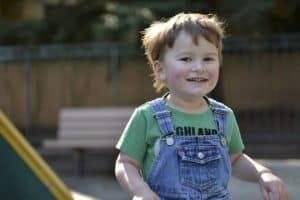Toddler boy in overalls