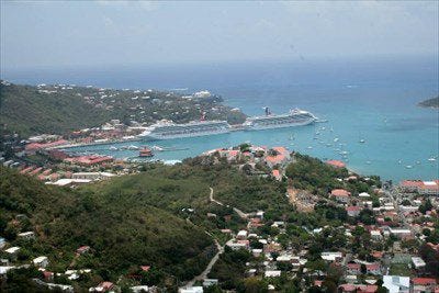 a view of the harbour in charlotte amalie with two cruise ships in port. The open ocean is in the background. One of the best views in St. Thomas besides Mountain Top.