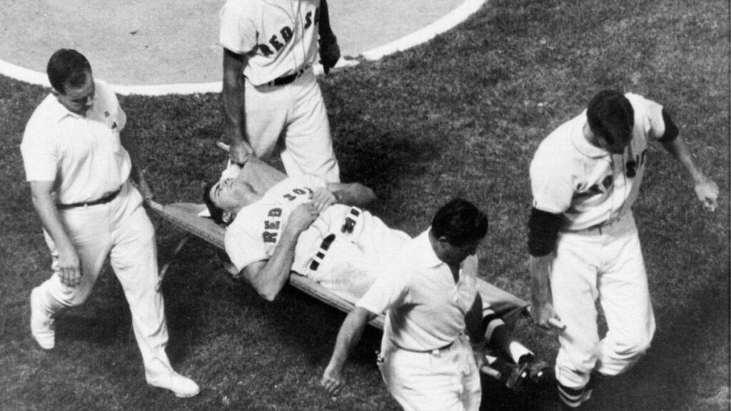 After being hit in the left cheek, Tony Conigliaro is taken off the field on a stretcher at Fenway Park.