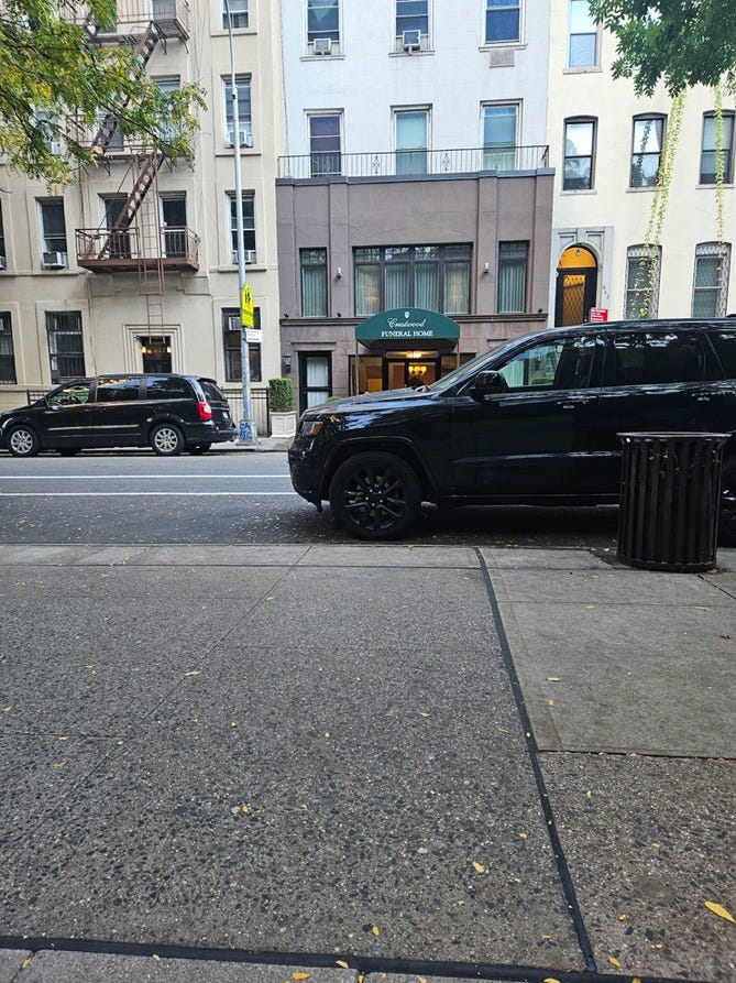 A black suv parked on a street

Description automatically generated
