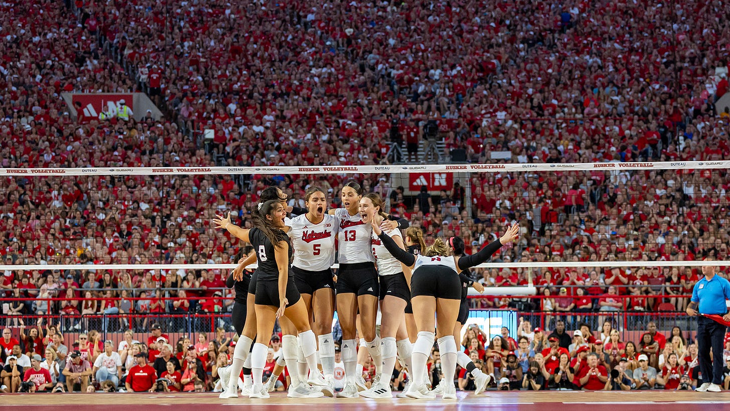 Nebraska volleyball celebrates a point in front of a world-record crowd at Memorial Stadium Aug. 30