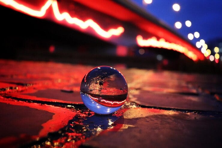 Close-up of wet crystal ball at night