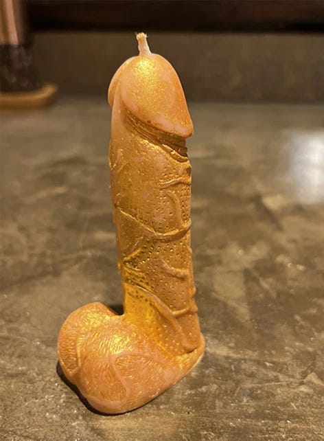 photo of a gold penis shaped candle