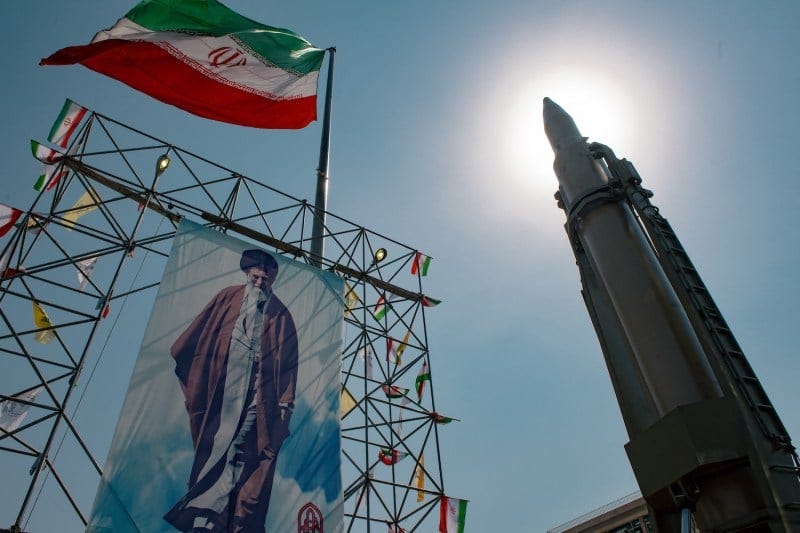 A banner depicting Iran’s Supreme Leader Ayatollah Ali Khamenei is placed next to a ballistic missile in Baharestan Square in Tehran on Sept. 26, 2024.