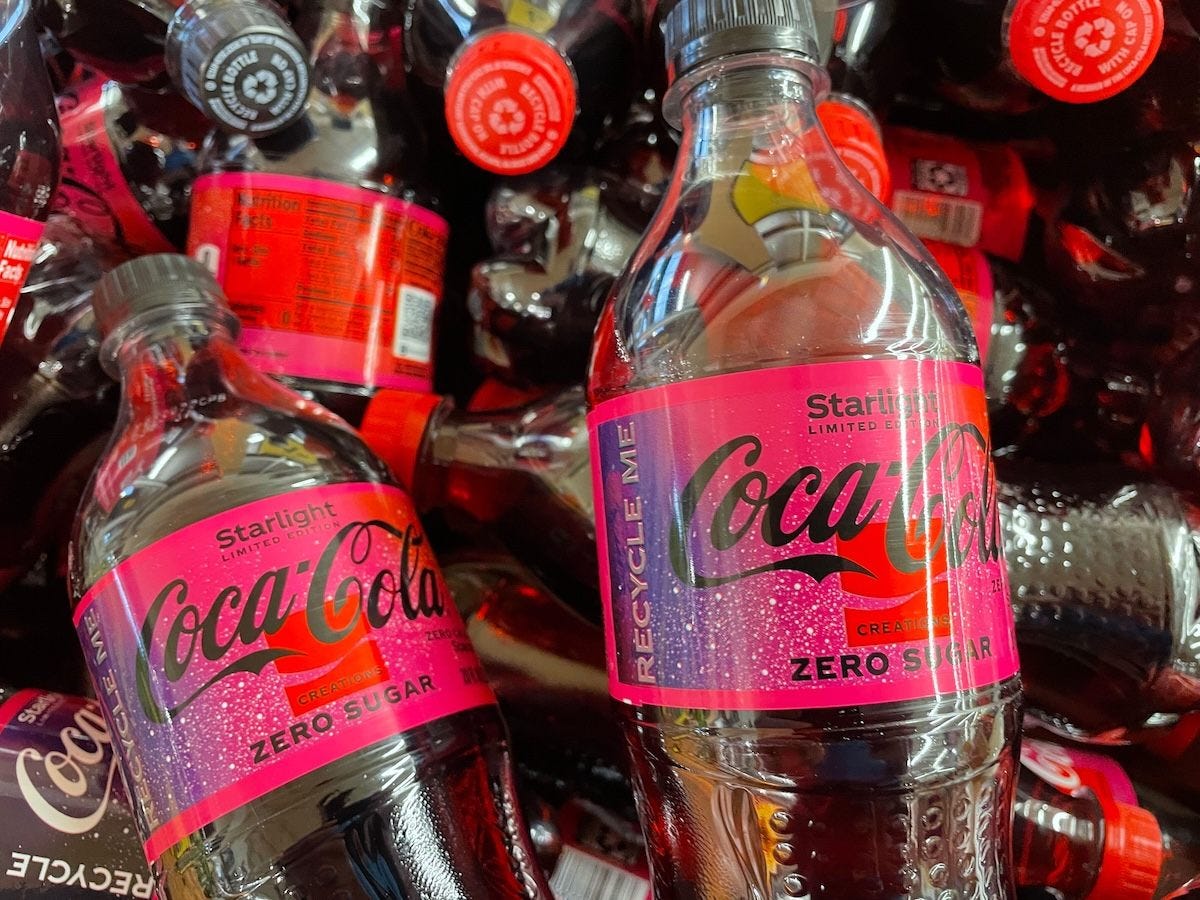 coke bottles with purple galaxy and white speckles as stars on the label