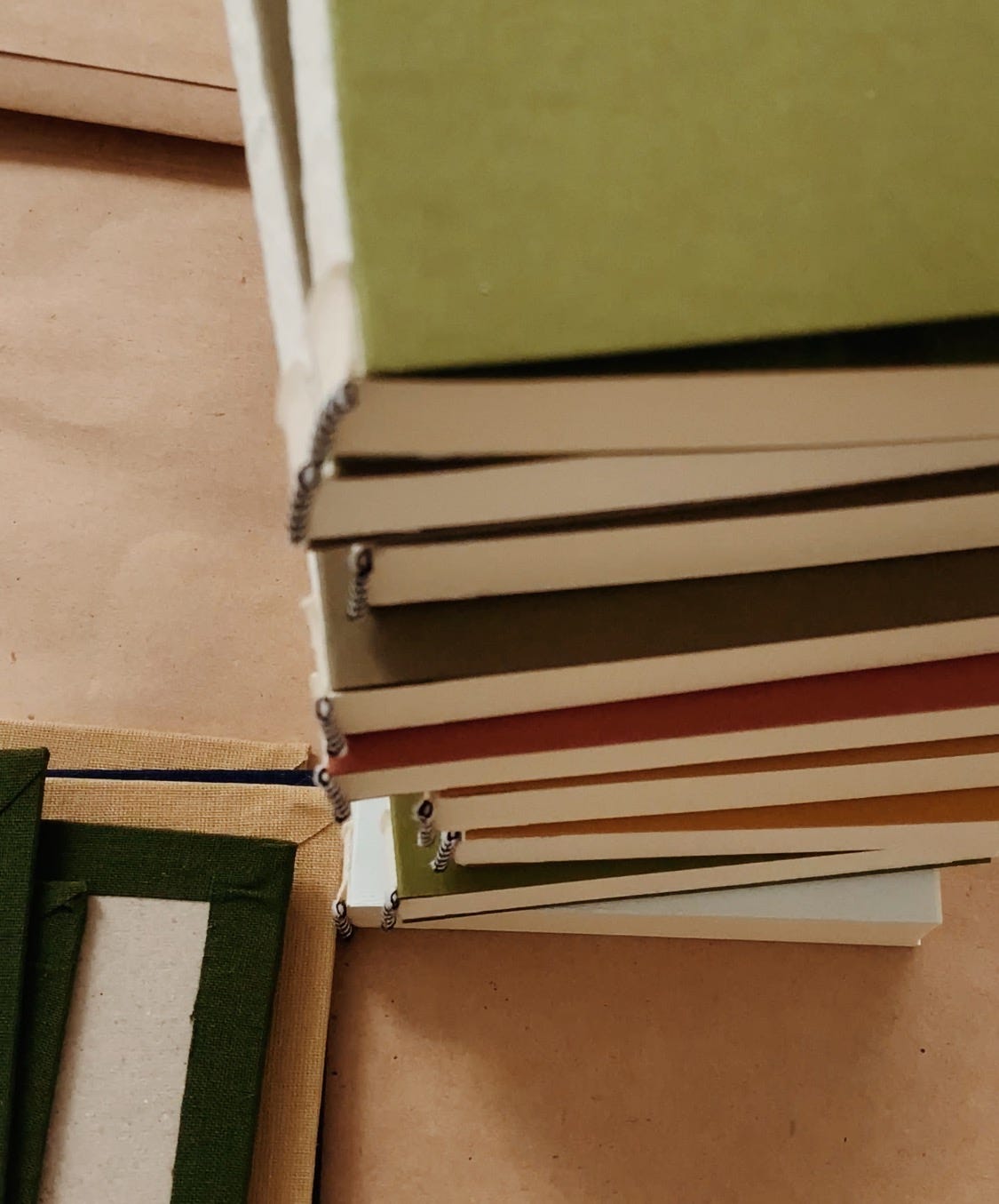 handmade books in a studio, colorful books in a pile